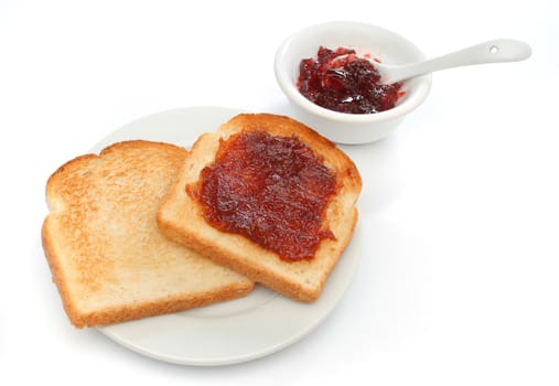 Two toast on a plate with red jam behind. Deliciuos food for breakfast. All white. Look at my gallery for more meals