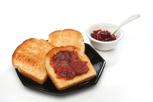 Three toast on a plate with  red jam behind. Deliciuos food for breakfast. White background.  Look at my gallery for more meals