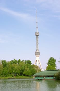 Large tv aerial near river over blue sky