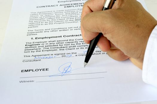 employment contract agreement being signed showing the form, hand and pen
