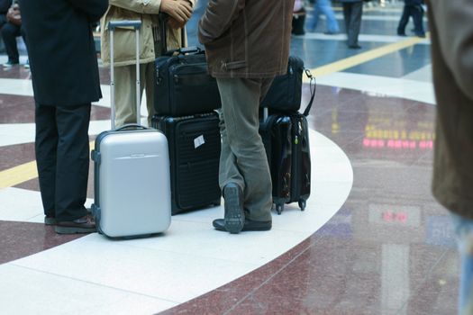 Departing passengers in waiting lounge with luggage