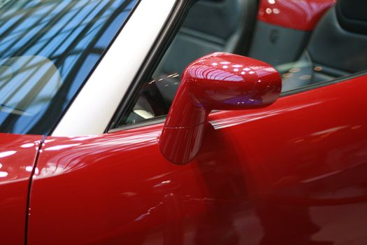 Left Side Mirror Of Shiny Red Sports Car