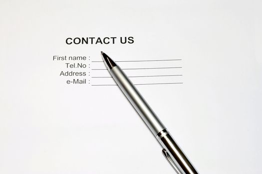 Contact Us in white background with pen