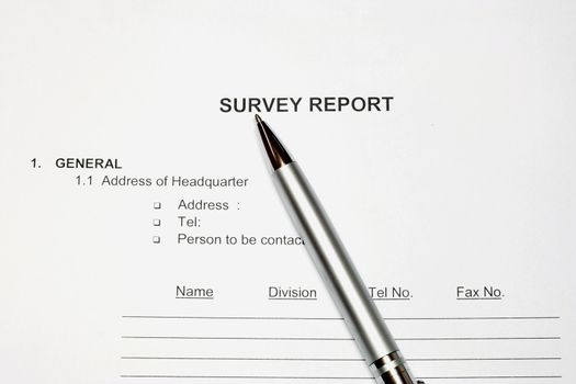 Survey Report in a white background with pen
