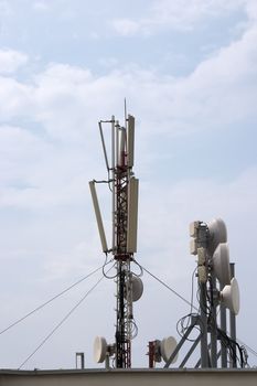 Cell antenna on roof over blue sky