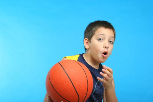 Boy playing basketball blue background. From my sport series.