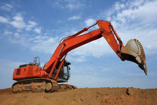 Catepillar loading sand and building a road.