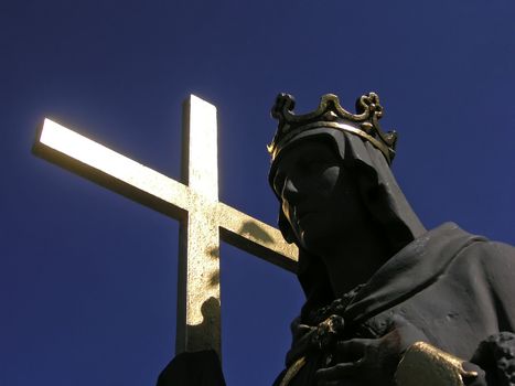 Black saint carrying a golden cross