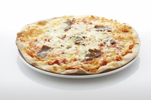 Pizza (filled with kebab, ham and blue cheese) on the plate over white background