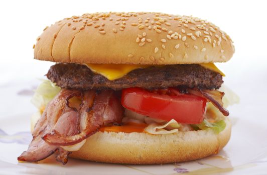 Big bacon cheese hamburger on the plate over white background