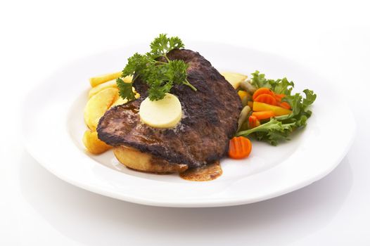 Steak with fried potatoes and vegetables over a white background