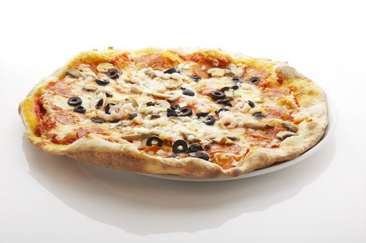 Pizza (filled with olives, mushrooms and shrimps)on the plate over white background