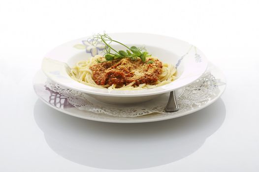 Spaghetti bolognese plate on shiny white table at the restaurant