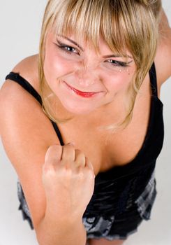 Flirting young healthy woman shaking her fist