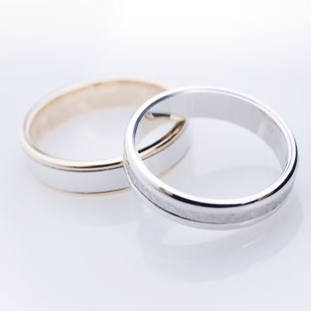 engament rings over a white reflective background