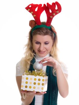 girl wearing a reindeer headband with a gift. Isolated on white 