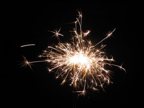 Sparkling fireworks in front of a black background.