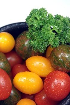 Three different variaties of cherry tomatoes, red, yellow pear and stripped green.