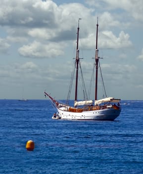 Two Boaters make their way to their yacht in a dingy