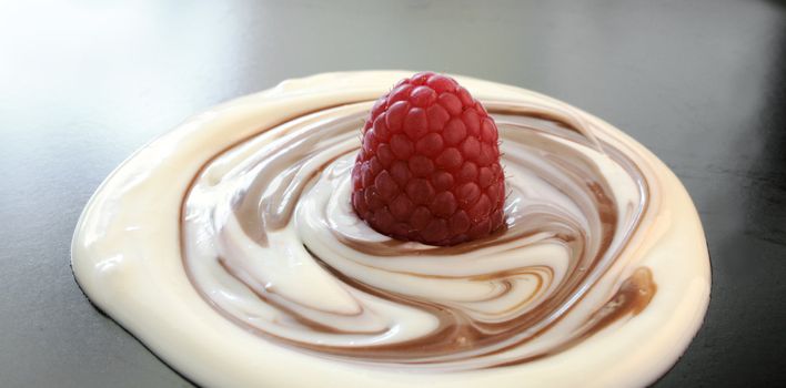 milk chocolate swirled into white chocolate topped with a red raspberry