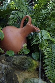 A clay water jug makes a decorative fountain