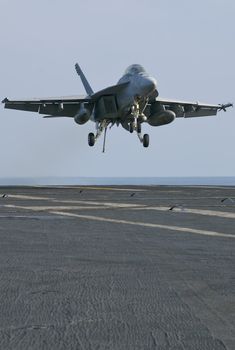 An F-18 Super Hornet moments away from trapping onboard a nuclear aircraft carrier