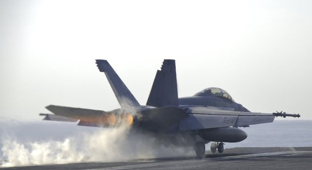 An F-18 Super Hornet screams down the catapult of a nuclear powered aircraft carrier