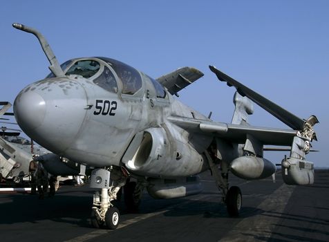 An EA-6B Prowler Electronic Attack aircraft taxies on an aircraft carrier