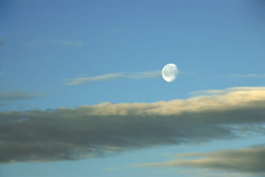 A beautiful moonrise in a cloudy twillight sky