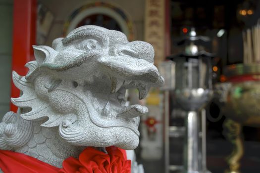 A Merlion, the mythical emblem of Singapore, stands guard outside a Buddhist shrine