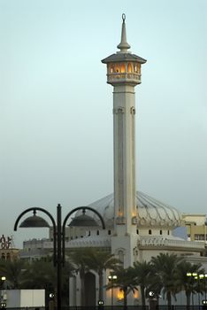 A Middle Eastern Mosque with lights at dusk