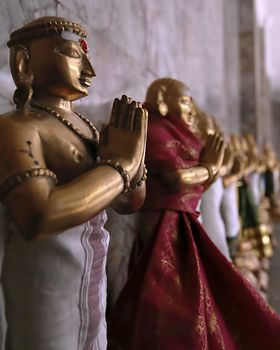 A line of small figurines adorn the inside of a Buddhist temple in Kuala Lumpur