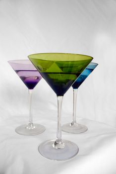 Brightly colored martini glasses on a white background