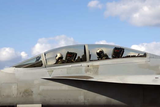 Two Naval aviators in the cockpit of their F-18 Super Hornet