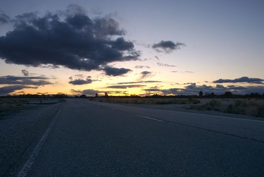 Sunset on a lonely desert road