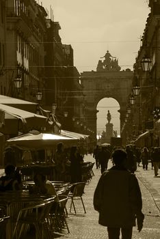 A busy commercial district, filled with shops and shoppers in sepia
