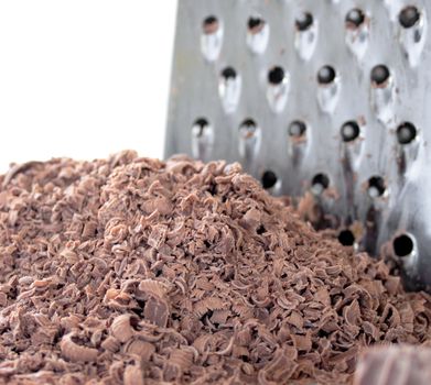 a heap of grated chocolate with a grater in the background