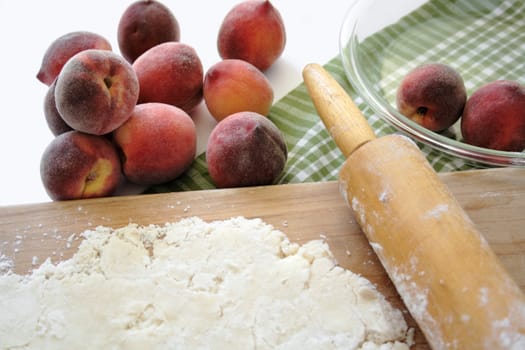 rolling out pastry for a homemade fresh peach pie