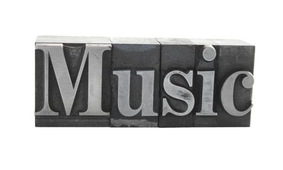 old metal letterpress letters form the word 'music' isolated on white