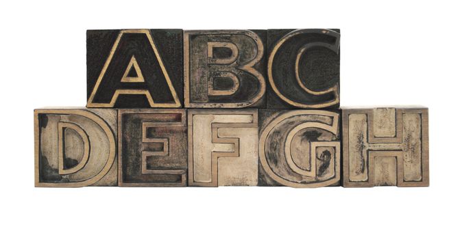 old, ink-stained letterpress wood outline type letters A-H