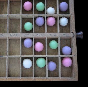 a wood type case with pastel balls in the slots