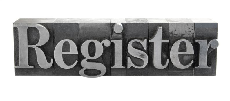 old, ink-stained metal letterpress type spells out the word 'register' isolated on white