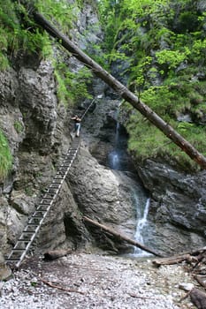 Tourist woman by the waterfall in Slovak Paradise