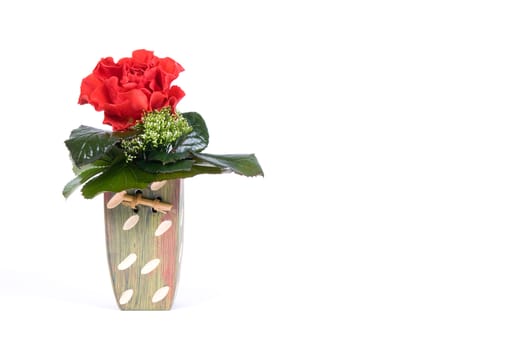 Arrangement with red rose in flower vase with empty space on the side