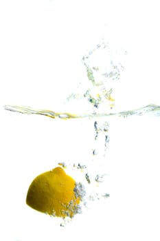 Big lemon splashing in water