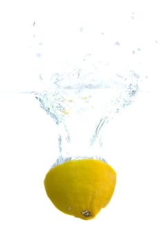 Big yellow lemon splashing in water