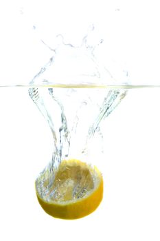 Big yellow lemon splashing in water