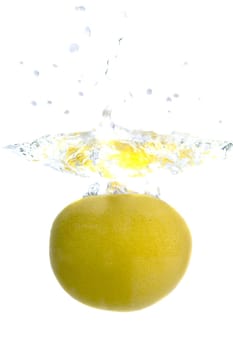 Big yellow lemon splashing in water