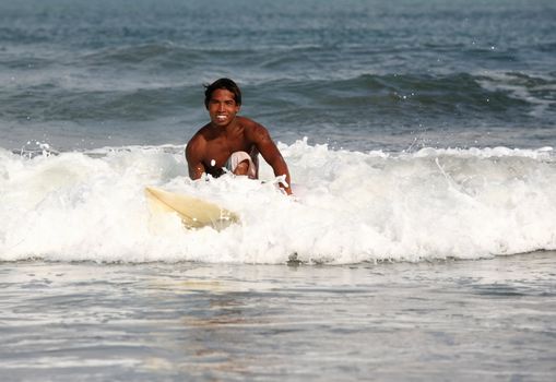 A surfer heading into the waves