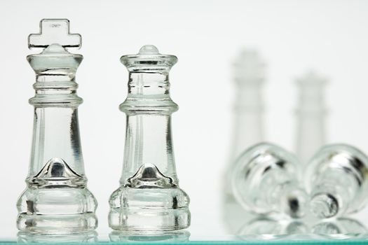 Chess transparent, white background, kings and queens. Two soldiers lie.